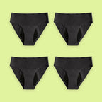 Pack de cuatro braguitas menstruales Apparelle Signature en negro, colocadas en cuadrícula sobre fondo lima